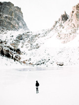 woman standing in a snow covered valley