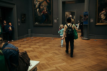 people walking through an art museum 