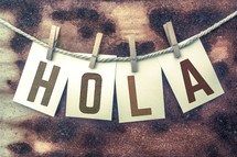 word hola on a clothesline 