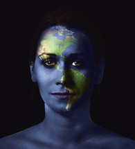 planet Earth painted on a woman's face