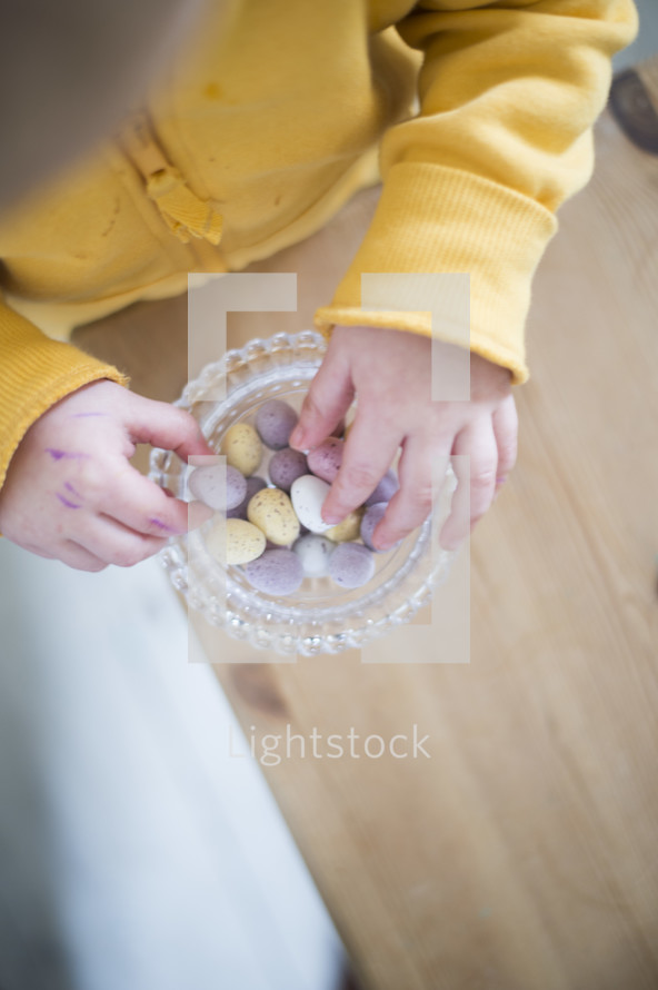 a child eating candy Easter eggs 