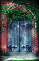 Arched wooden doors from an abandoned Gothic revival church in a downtown city.