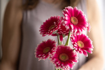 Woman holding bouquet of pink flowers close up