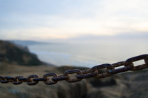 rusty chain near a shore 