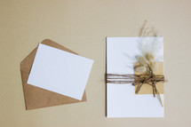 envelope with twine and fuzzy grasses 