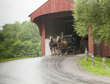 Amish carriage going through a covered bridge 