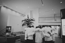Groomsmen praying with the groom before the wedding