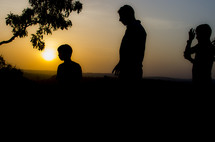 silhouettes of people at sunset 