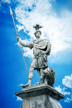 fierce warrior statue with lion  