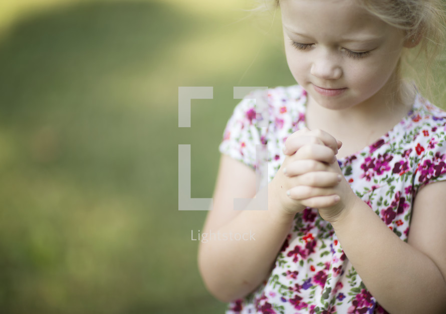 a child with praying hands 