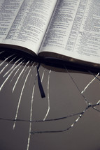 Bible behind cracked glass
