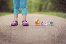 a child's feet and My Little Ponies 