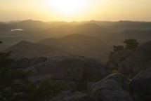 sunset over rocks on a mountaintop 