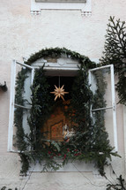 Christmas garland and star decorations in a window 
