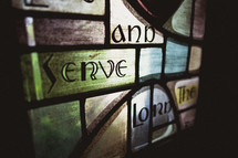 Stained window glass - go and serve the Lord