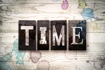 word time on a white wash wood background 