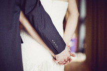 A wedding couple holding hands