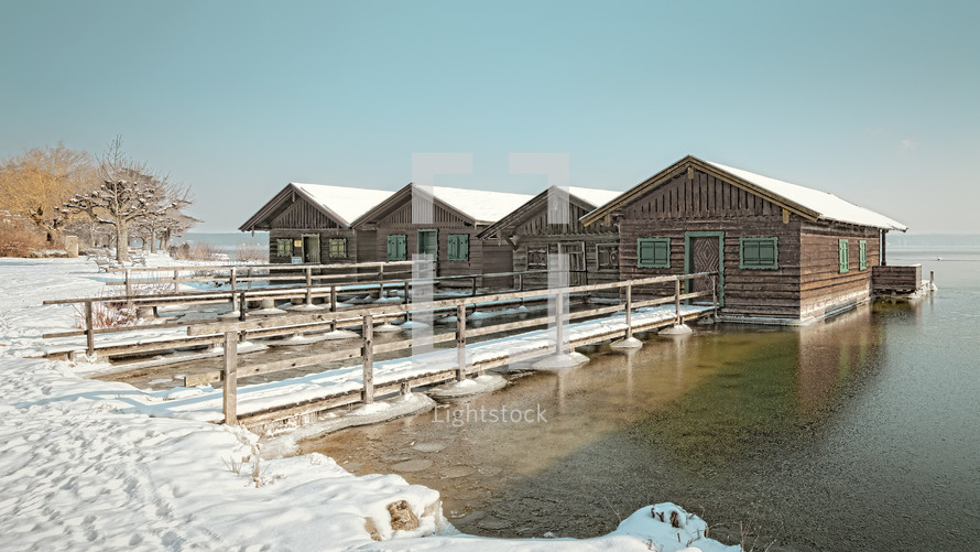 docks and boat houses on the water and snow
