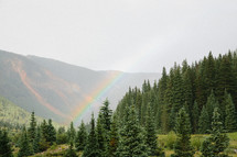 a rainbow in a mountain valley 