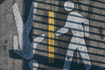 Pedestrian crossing symbol on asphalt 