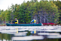 men rowing a canoe 