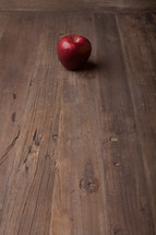 apple on a wood desk 