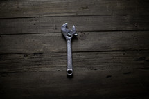 a wrench on a workbench 