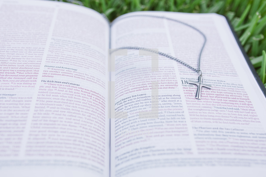 open Bible and a cross necklace 