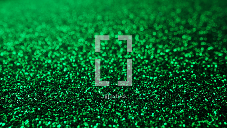 Abstract emerald background with shining sparkles. Glittering Particles surface. Festive dust. Beautiful texture, bokeh. New Year party concept.