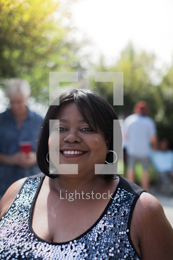 headshot of an African American woman at a backyard summer party 