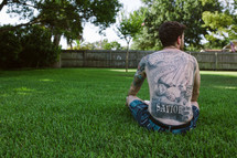 man with religious tattoos on his back 