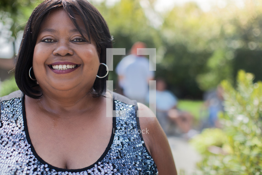 headshot of an African American woman at an outdoor summer party 