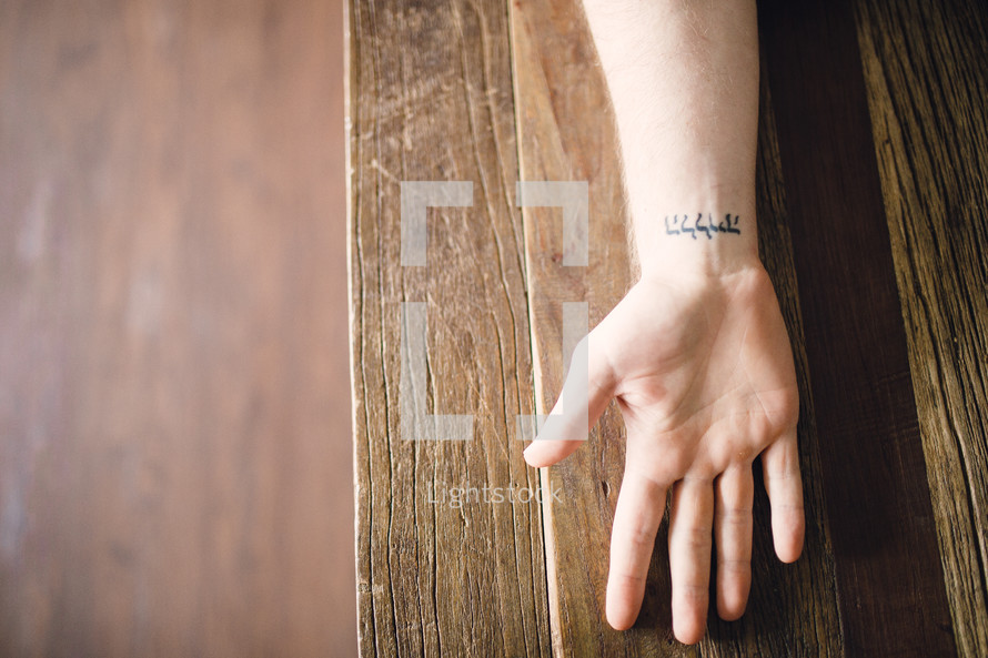 hebrew writing tattoo on a wrist 
