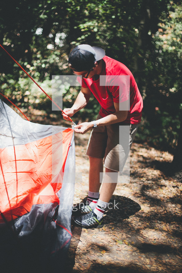 man setting up a tent 
