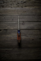 a screwdriver on a workbench 