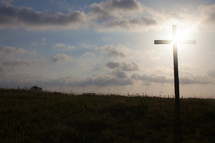 rays of sunlight behind a cross 