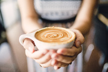 woman holding a cappuccino mug