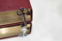 key leaning against a Bible