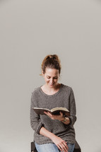 woman sitting and reading a Bible 