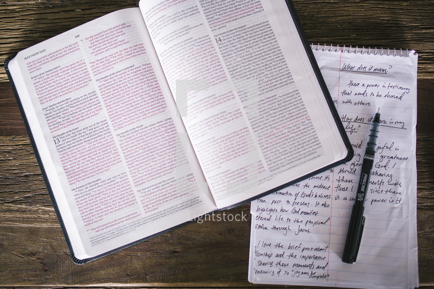 open Bible and notes on a notepad 