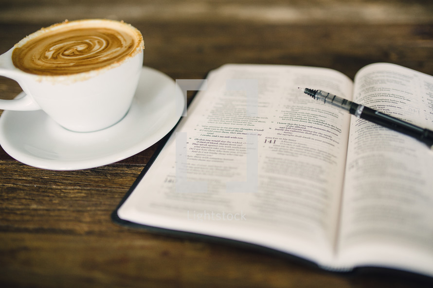 cappuccino and an open Bible and pen 