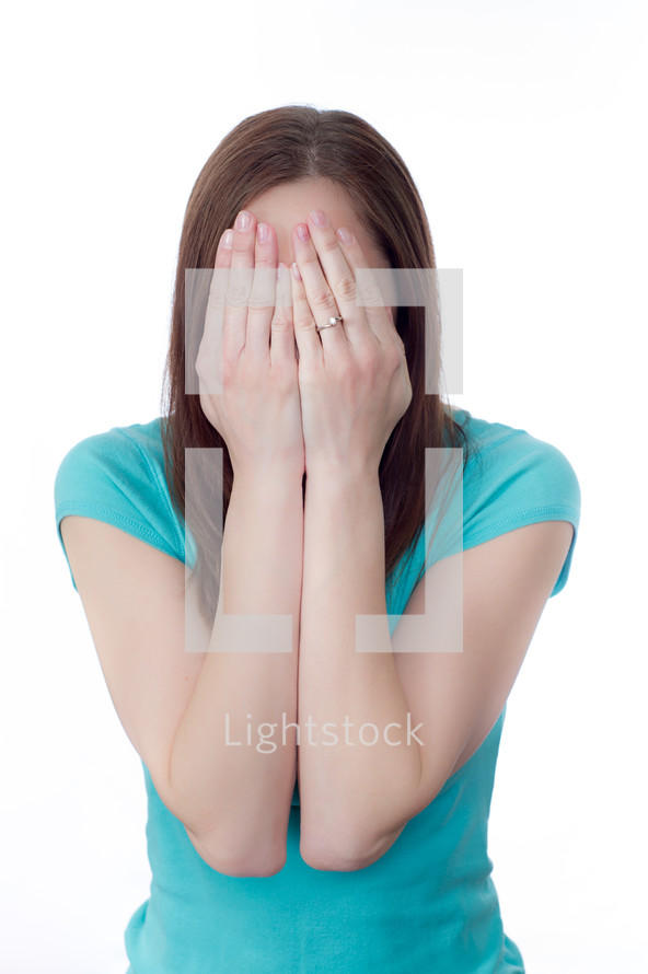 woman hiding her face in her hands