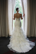 bride standing in a window 