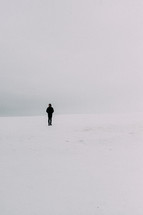 man standing alone in snow 