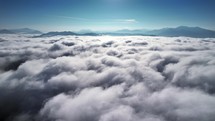Slowly flying above the clouds peaceful relaxing background, real drone footage