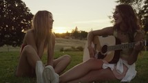 Girl Plays Guitar Outside with Friend in Slow Motion