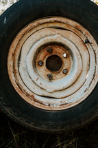 Close up of a rusty old tractor tire.