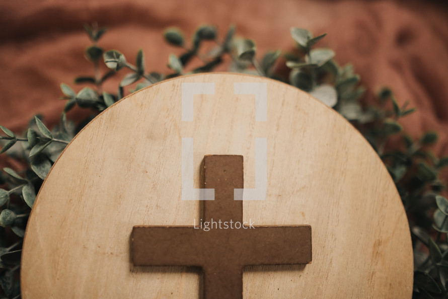 cross on a wooden circle 
