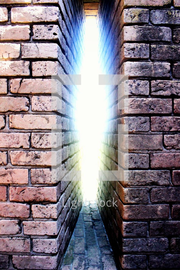 escaping light between brick walls 