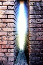 escaping light between brick walls 